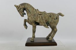A Japanese cast metal model of a horse mounted to wooden plinth, approximately 24 cm (h).
