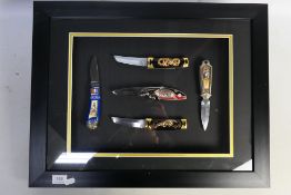 A framed display of five Franklin Mint c