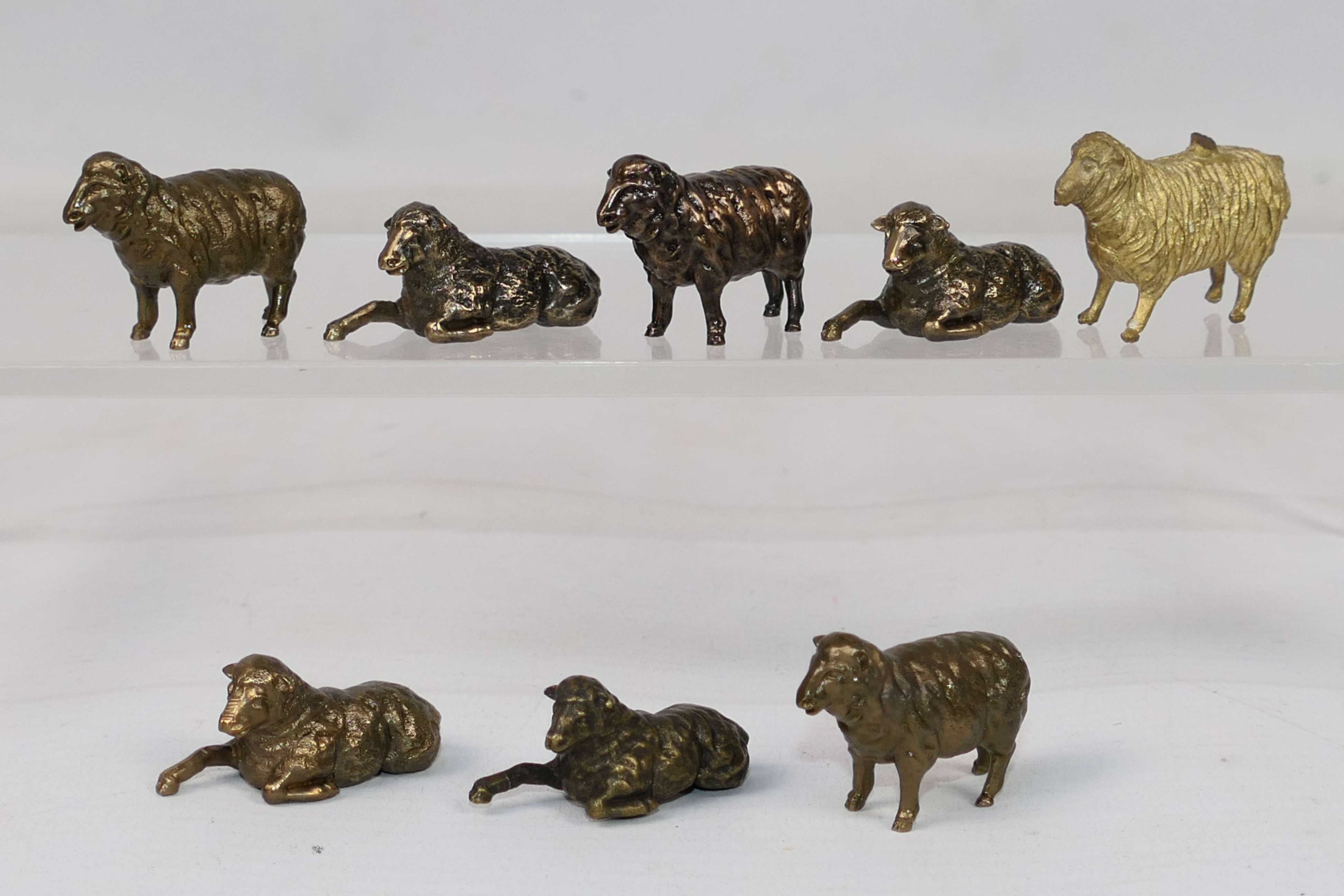 8 x small bronze sheep figures. All in s