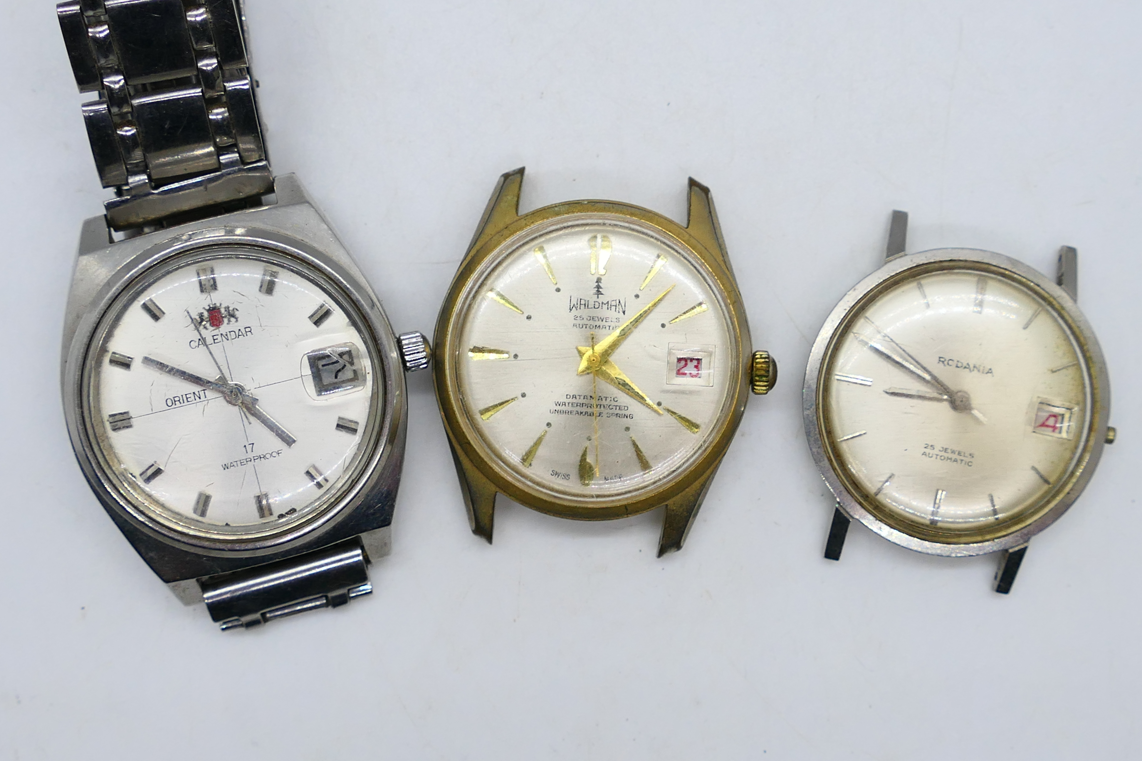 Three gentleman's wrist watches to include Waldman, Rodania (both lacking straps) and other.
