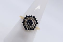 A 9ct yellow gold diamond and sapphire cluster ring, size N, approximately 2.5 grams.