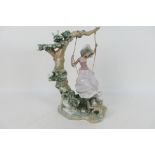 Lladro - A large Lladro figure entitled Swinging # 9163 depicting a young lady on a swing with a