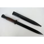 A German K98 bayonet, 25 cm single edged blade, with steel scabbard marked Gebr Heller 1939,