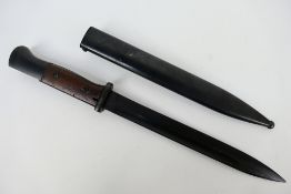 A German K98 bayonet, 25 cm single edged blade, with steel scabbard marked Gebr Heller 1939,