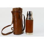 An early 20th century leather clad, chrome plated Thermos flask,