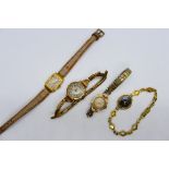 Four lady's wristwatches comprising a yellow metal example with expanding bracelet,