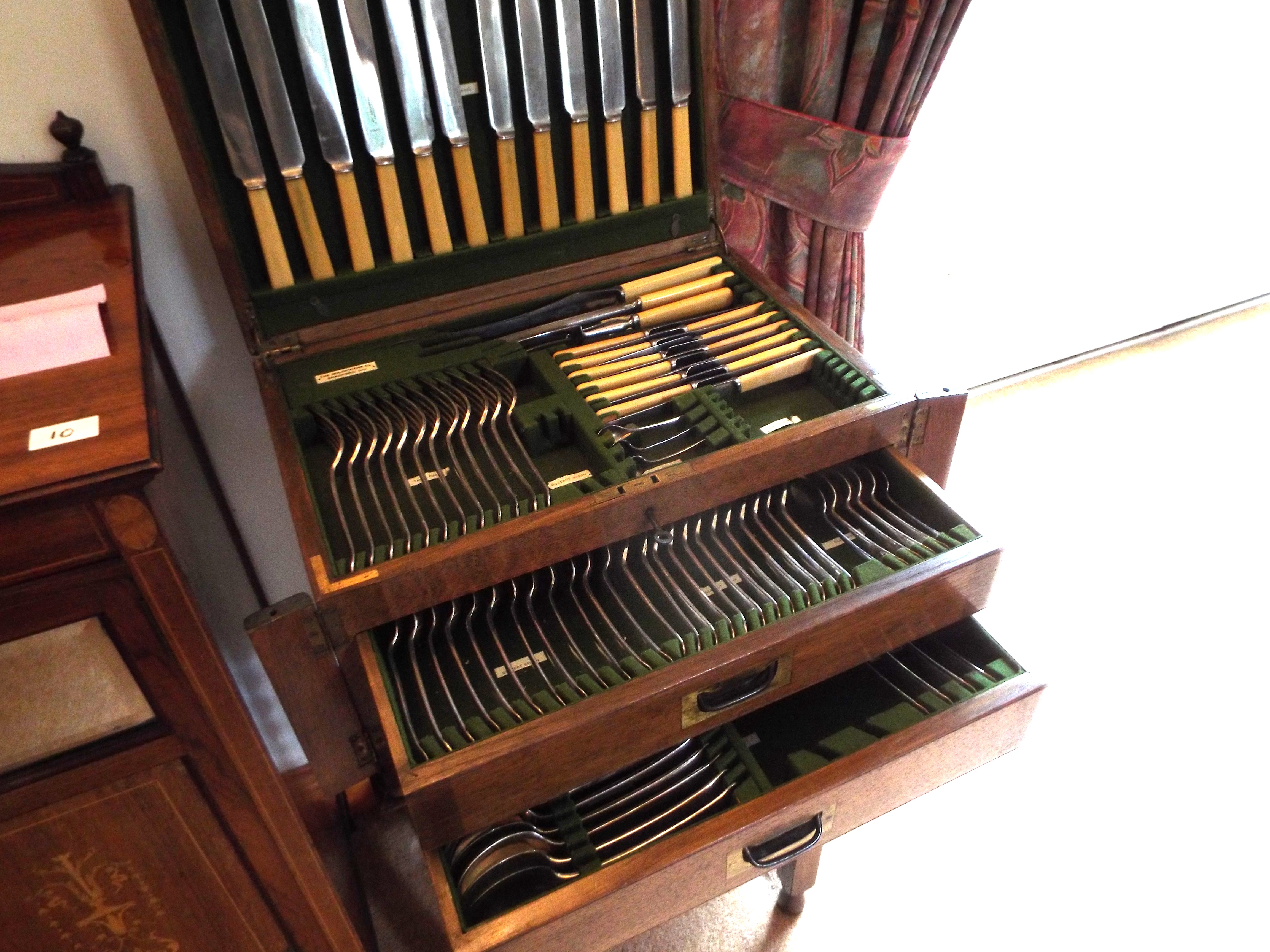 A 12-place setting, 94 piece canteen of cutlery by Goldsmiths of Bradford housed in an oak,