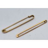 A hallmarked 9ct gold tie pin and one further stamped 9ct, approximately 4.9 grams.