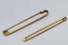A hallmarked 9ct gold tie pin and one further stamped 9ct, approximately 4.9 grams.