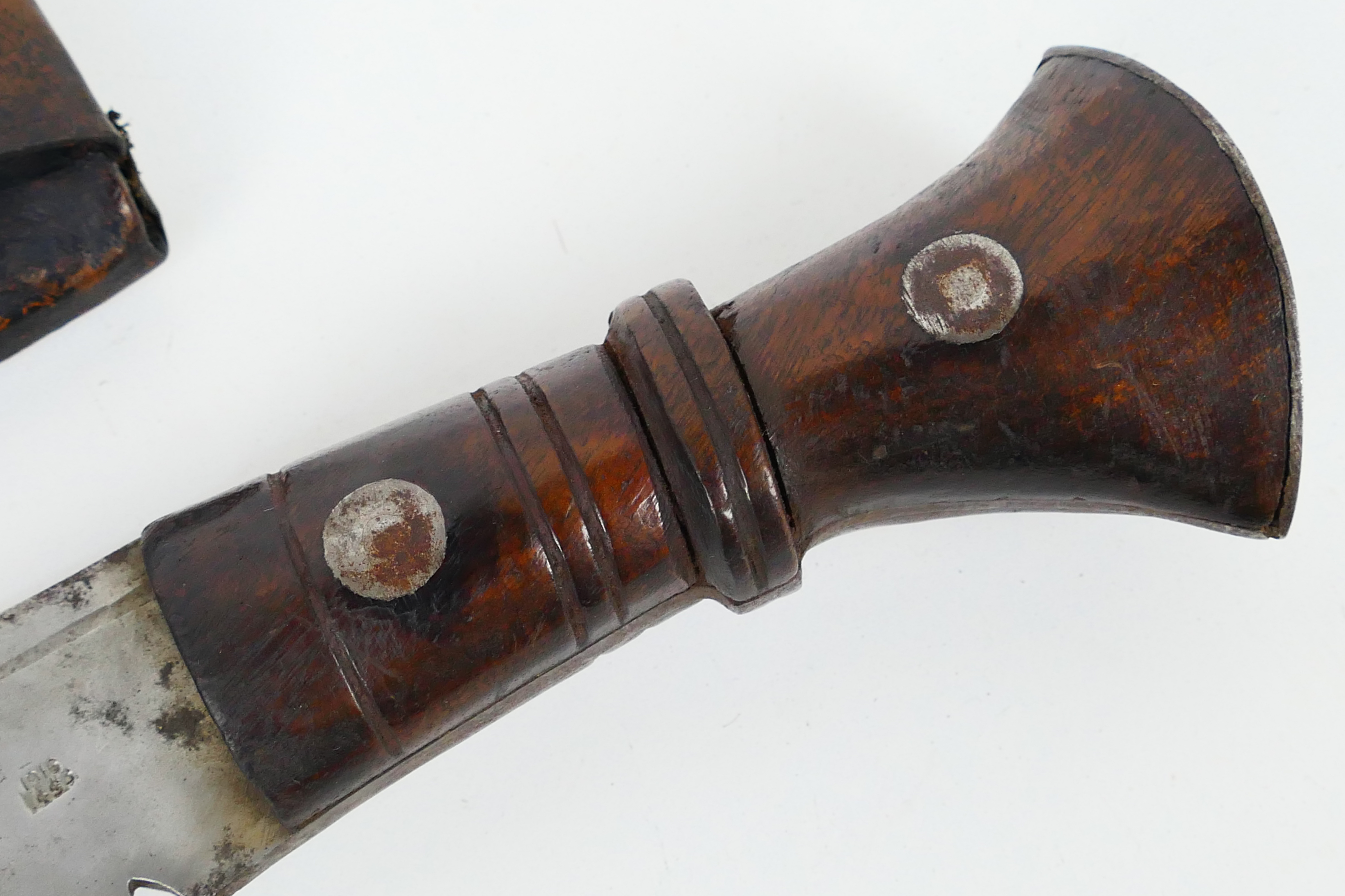 A Gurkha kukri knife, dated 1916, turned wooden hilt with metal pommel, housed in leather sheath. - Image 3 of 9