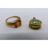 A 9ct gold stone set dress ring, size O+½, 2.3 grams and a stone set yellow metal pendant.