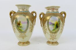 Noritake - A pair of twin handled vases with hand painted landscape scene panels depicting a