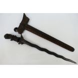 An Indonesian Kris with intricately carved scabbard and hilt,