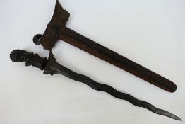 An Indonesian Kris with intricately carved scabbard and hilt,