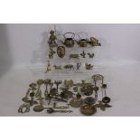 A collection of brass items to include a bird, mask, elephant, and similar.