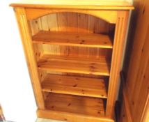 A pine bookcase measuring 107 cm (h) x 75 cm (w) x 31 cm (d),