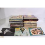 A collection of predominantly 12" vinyl records to include The Beatles, The Who, Cat Stevens,