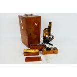 An early 20th century lacquered brass and black lacquer monocular microscope by E Leitz Wetzlar,