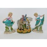 A pair of European ceramic figures depicting young girls,