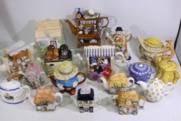 A collection of various novelty teapots, two boxes.