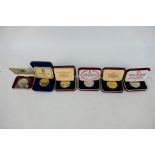 Six cased Isle Of Man silver crowns to include three Manx Cat,