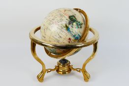 A gemstone terrestrial globe, approximately 36 cm x 30 cm.