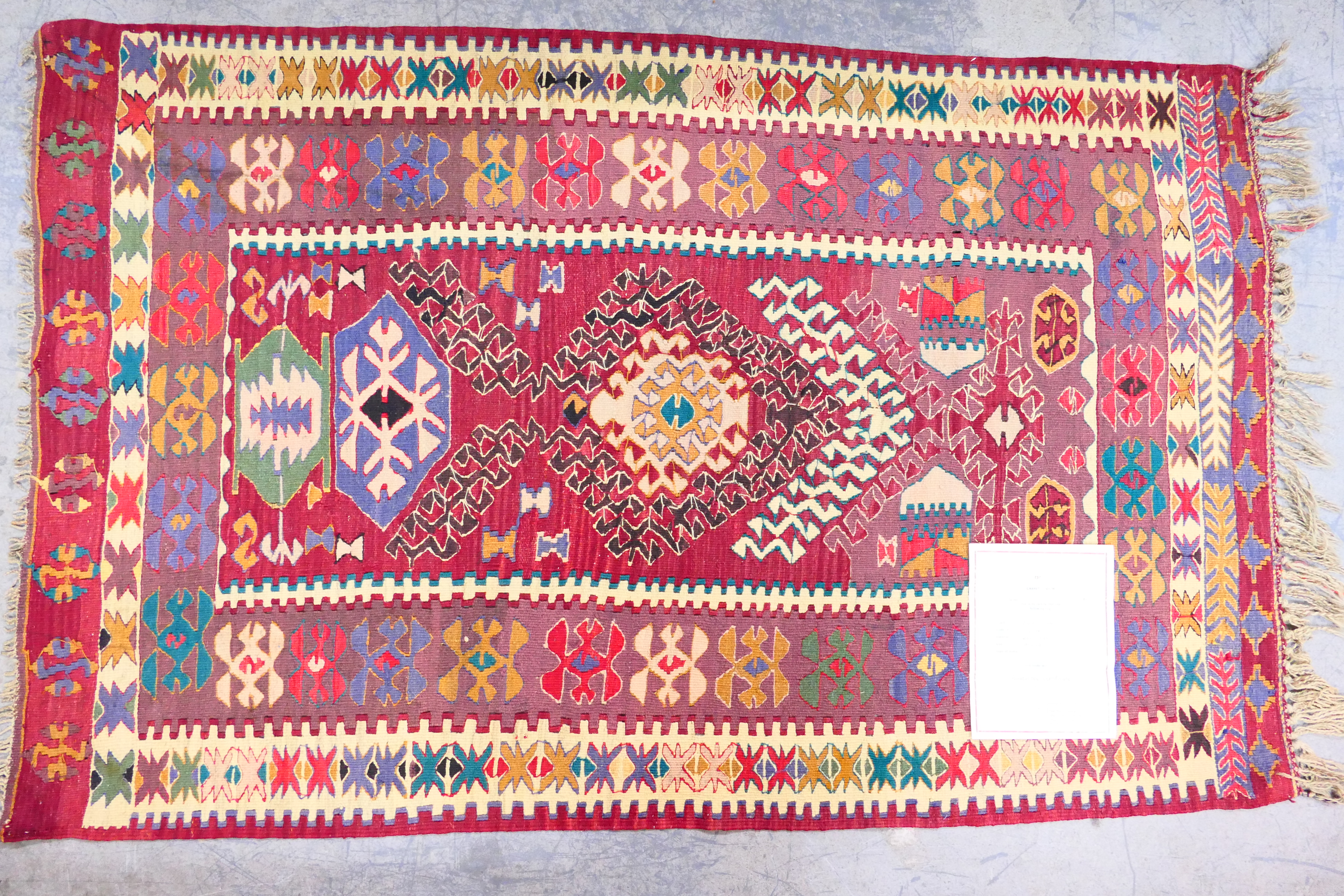 A Turkish wool rug, approximately 180 cm x 110 cm.