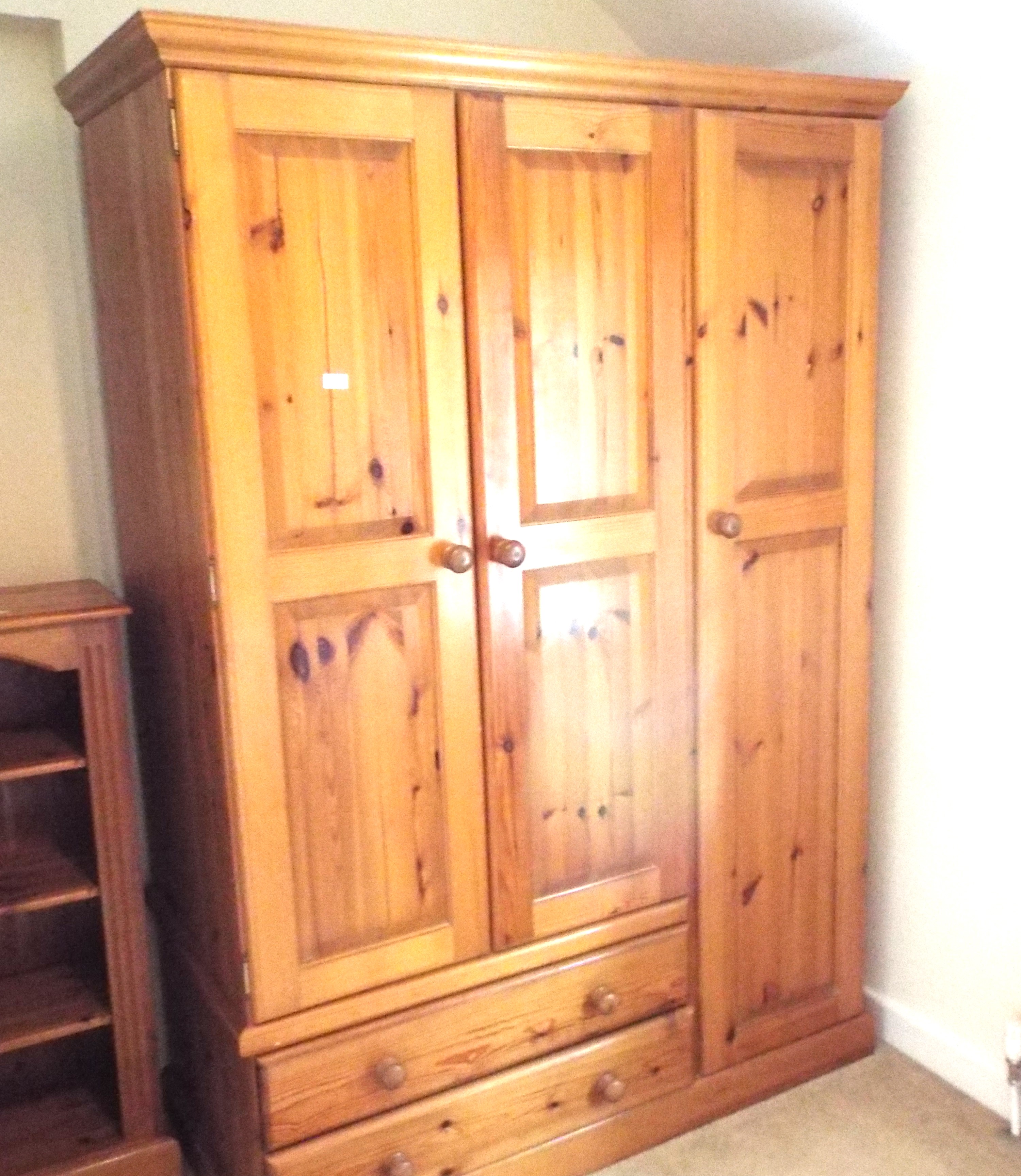 A pine wardrobe measuring 191 cm (h) x 132 cm (w) x 62 cm (d),