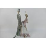 Lladro - A large figure group depicting an Edwardian couple with a puppy (lady is lacking the