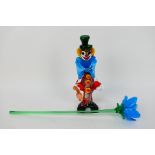 A Murano glass clown, approximately 30 cm (h) and a glass flower.
