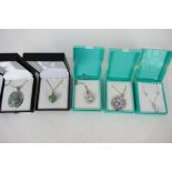 A collection of white metal, stone set pendants and chains,