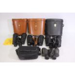 Four cased pairs of binoculars.