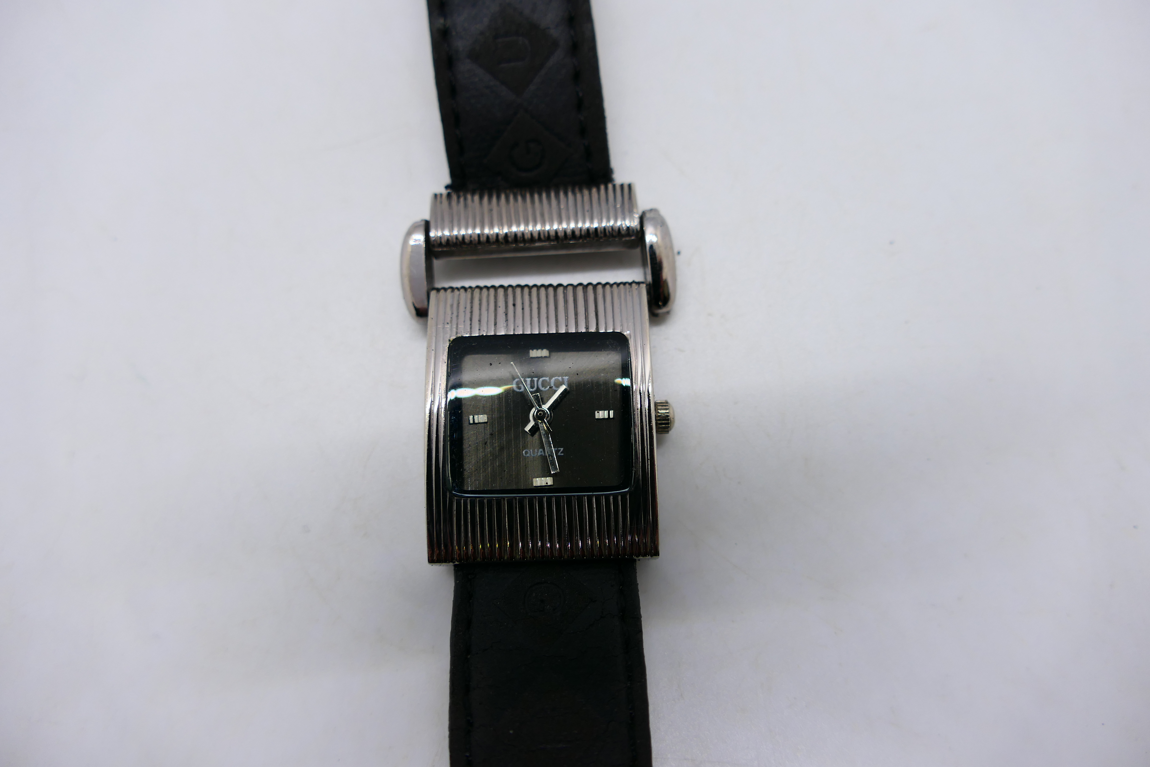 A lady's fashion watch, marked Gucci to the black dial, on black leather strap. - Image 2 of 3