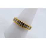 An 18ct two tone gold band ring, size Q+½, approximately 7.1 grams.