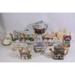 A collection of novelty teapots to include The Rovers Return, The Woolpack and The Queen Victoria,