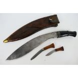 A Nepalese kukri knife, 35 cm (l) blade, turned wood hilt with brass pommel,