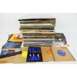 A collection of 7" and 12" vinyl records to include musicals, Billy Joel, Starship, Lionel Richie,