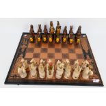 A Royal Beasts Queens Coronation chess set with 16 cm king.