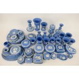 A quantity of pale blue Wedgwood Jasperware to include trinket boxes, powder bowls, candlesticks,