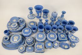 A quantity of pale blue Wedgwood Jasperware to include trinket boxes, powder bowls, candlesticks,
