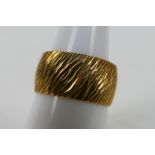 A 9ct yellow gold textured band ring, size N+½, approximately 5.