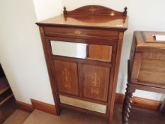 An Edwardian cabinet, the front door with lock and key, opening to reveal a shelved interior, good,