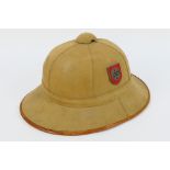 A German tan pith helmet with brown leather chin strap, size 57,