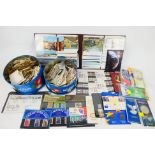 Philately - Two tins of loose stamps, uncirculated coins, binder of postcards and other.