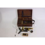 A J Swift & Son black lacquered monocular microscope in mahogany field case with accessories.
