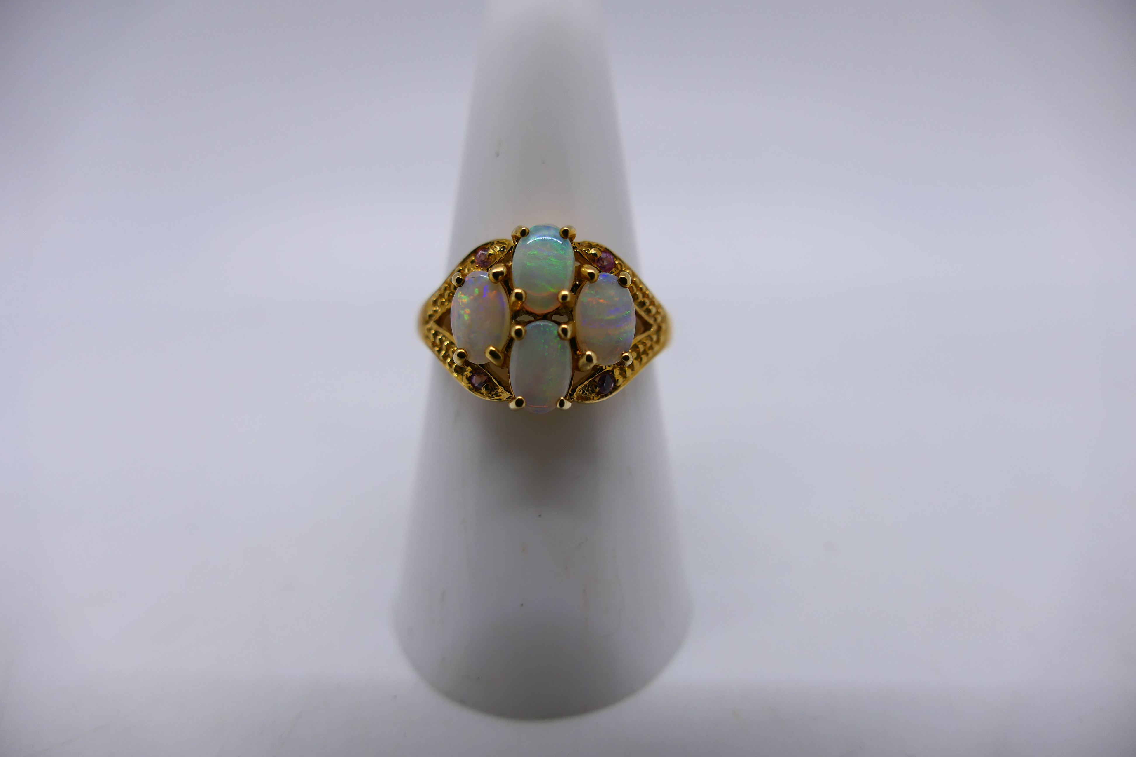 A 9ct yellow gold ring set with four white opal cabochons, size N and a yellow metal, - Image 3 of 5