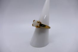 A 9ct yellow gold ring set with a white opal cabochon, size N, approximately 3.9 grams.