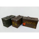 Three metal, military ammunition boxes.