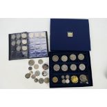 A coin wallet containing a collection of Isle of Man coinage, various 50 pence (50p) pieces,