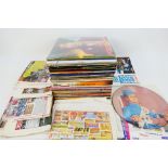 A collection of 12" vinyl records to include Jimi Hendrix, Bob Marley and other.